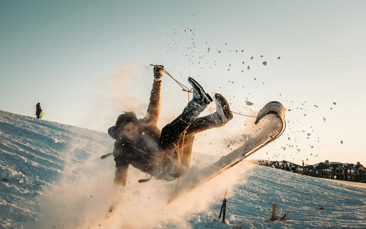 Skier falling in a spray of snow.