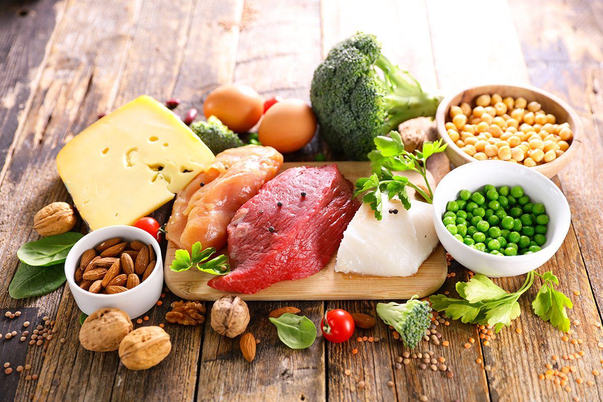 Protein-rich foods laid out on a wood platter.
